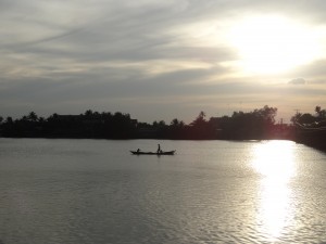 Pendant le crépuscule, une barque glisse le long de la rivière Teuk Chhou